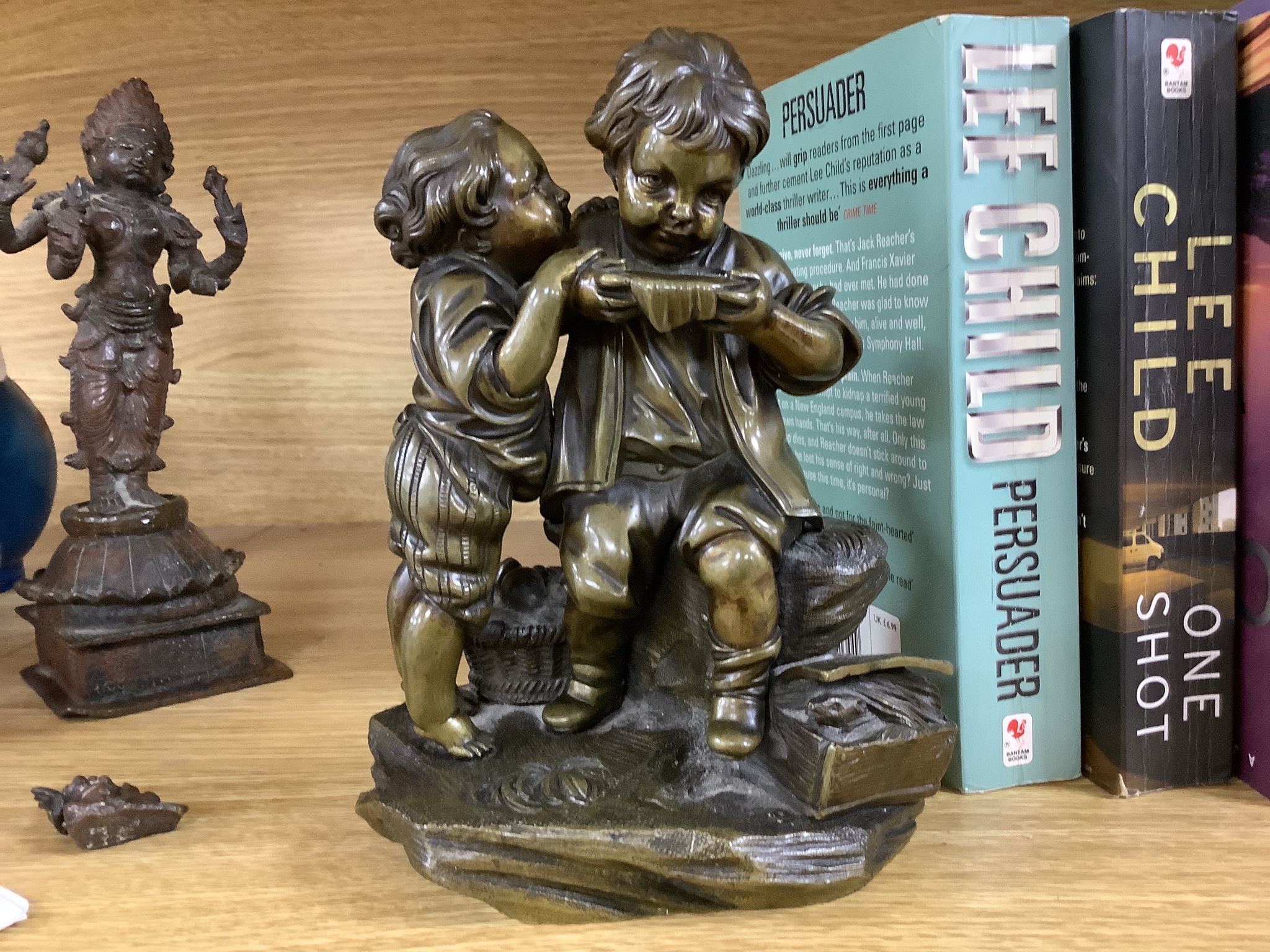 A bronze group of two children and two Indian bronze figures, tallest 20cm